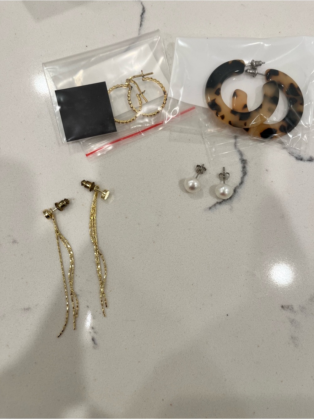 10 pierced earring sets. Pearl, crystal, hoops, as shown.